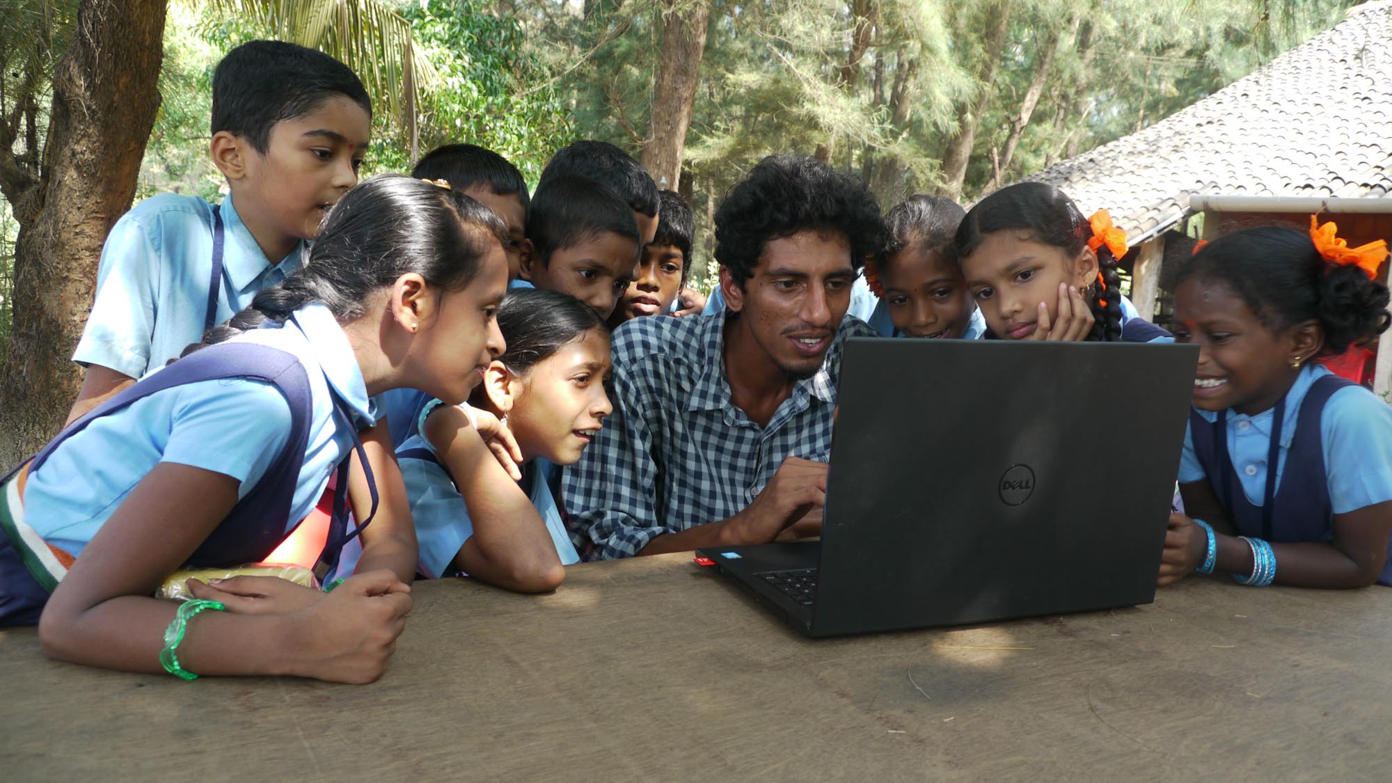 Students and a facilitator reviewing photographs from a nature-walk field programme
